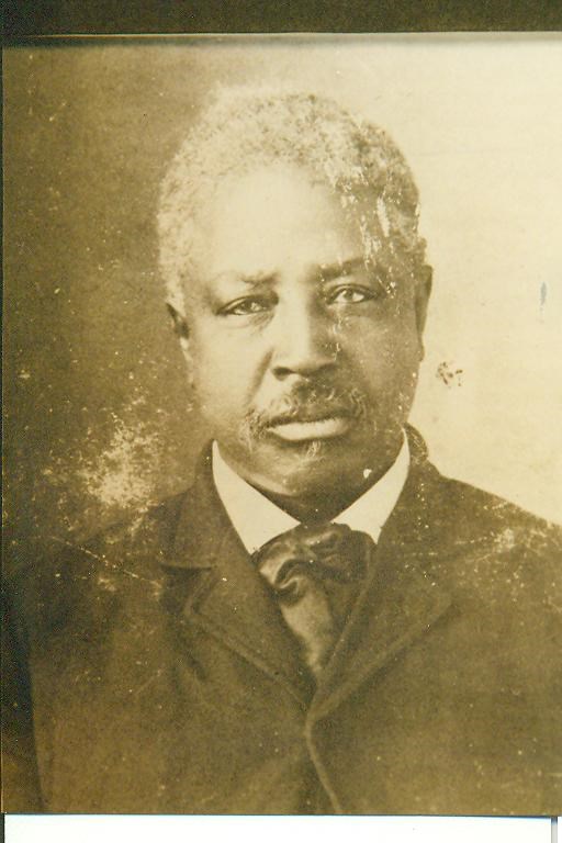 A sepia photo of a man in a suit