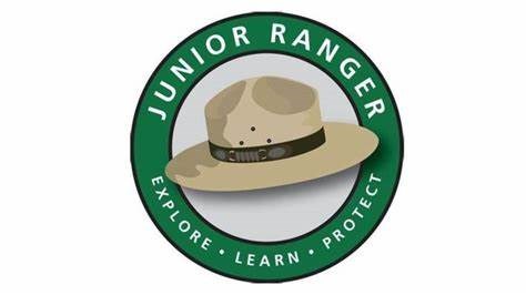 A flat ranger hat is tan with a brown band around it.