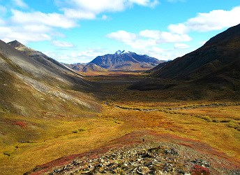 A valley between two mountains with fall colors