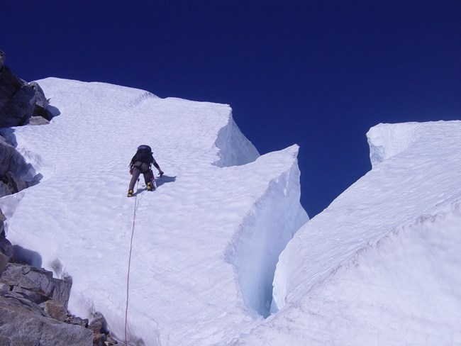 Roped climber ascending glacier on Mt. Challenger, Picket Range