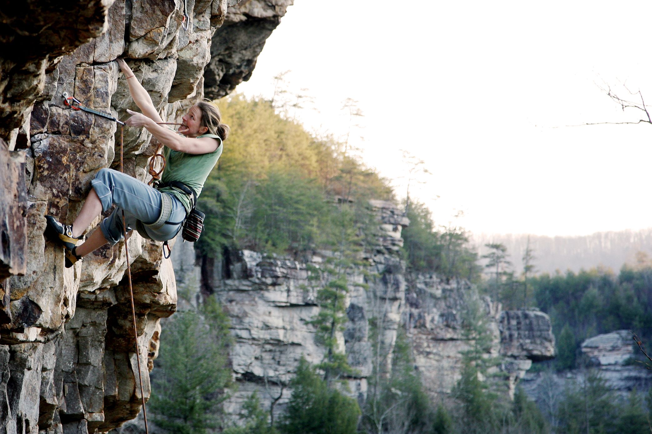 Climger hanging from rock face