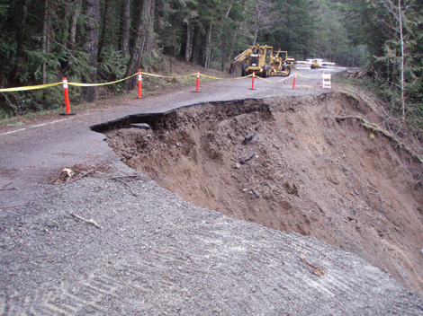 large landslide below a road; much of road is missing