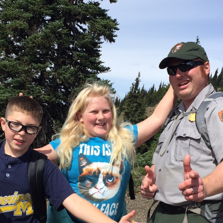 uniformed ranger with a boy and a girl