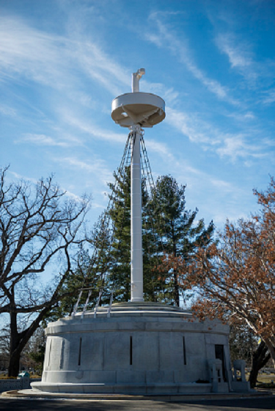 A tall and white structure with a poll in the middle