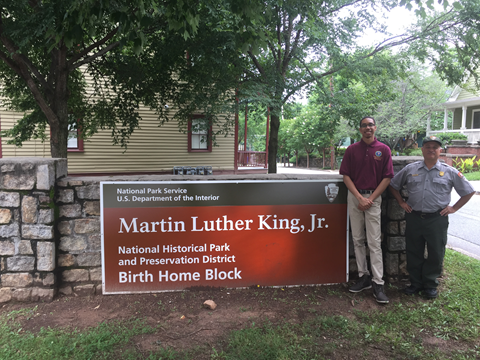 Architecture intern from Tuskegee Institute meets HPTC Senior Historical Architect, Tom Vitanza Two people standing next to a sign that reads "Martin Luther King Jr."