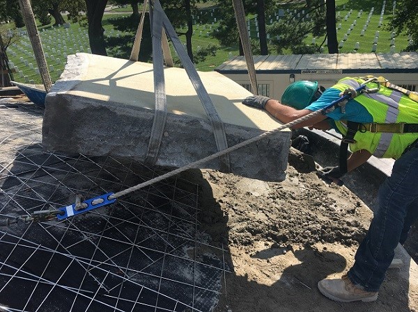 HPTC member lowering stone shingle to the ground