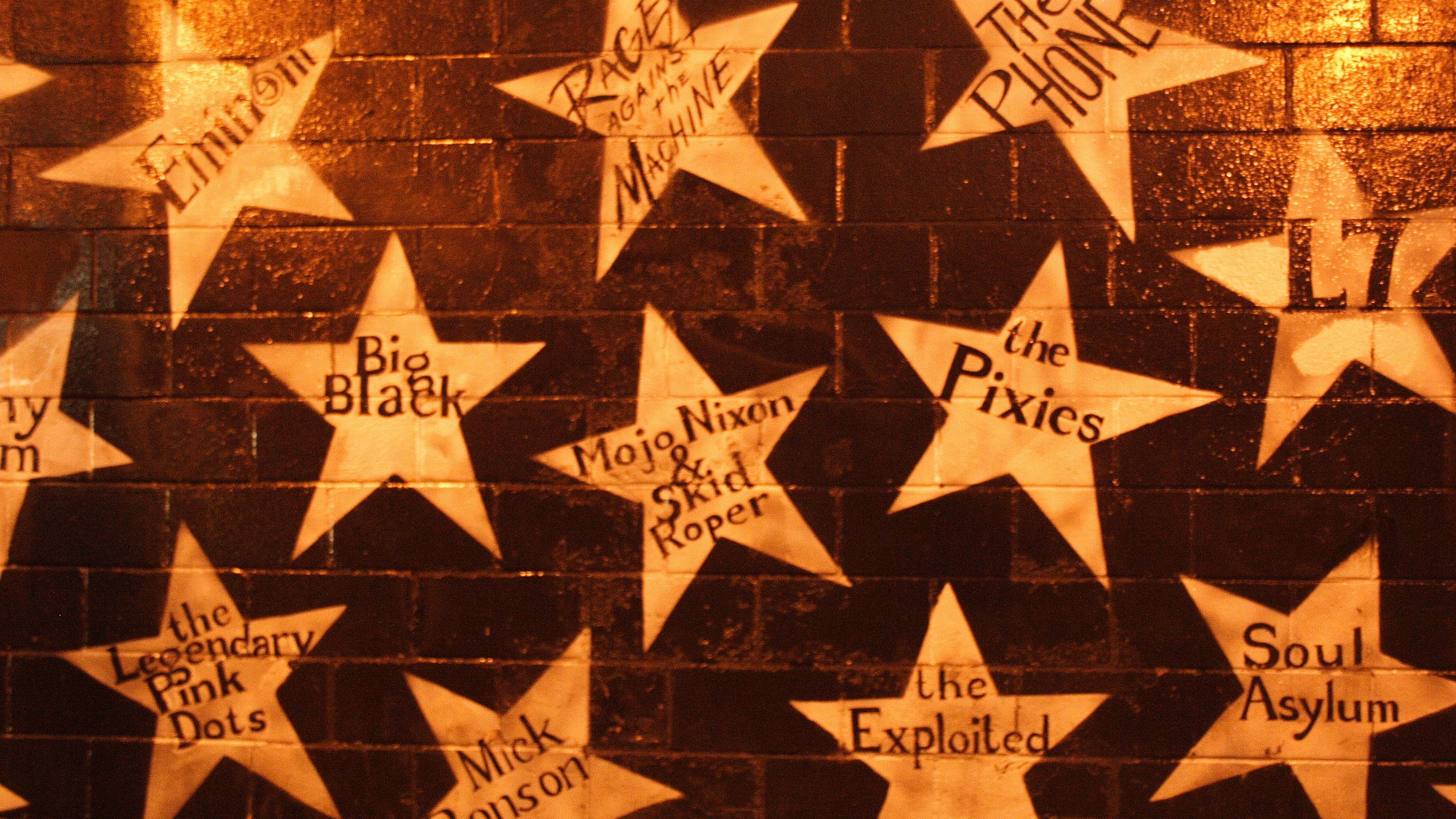 Exterior of a building painted with large stars containing various musical artist's names.