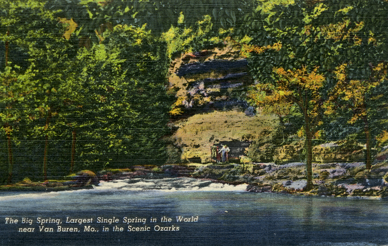 An old fashion color tintype postcard of big spring showing a bluff and spring pouring from the base. People are standing on the edge of the spring. Text reads: The Big Spring, Largest single spring in the World near Van Buren, Mo, in the Scenic Ozarks