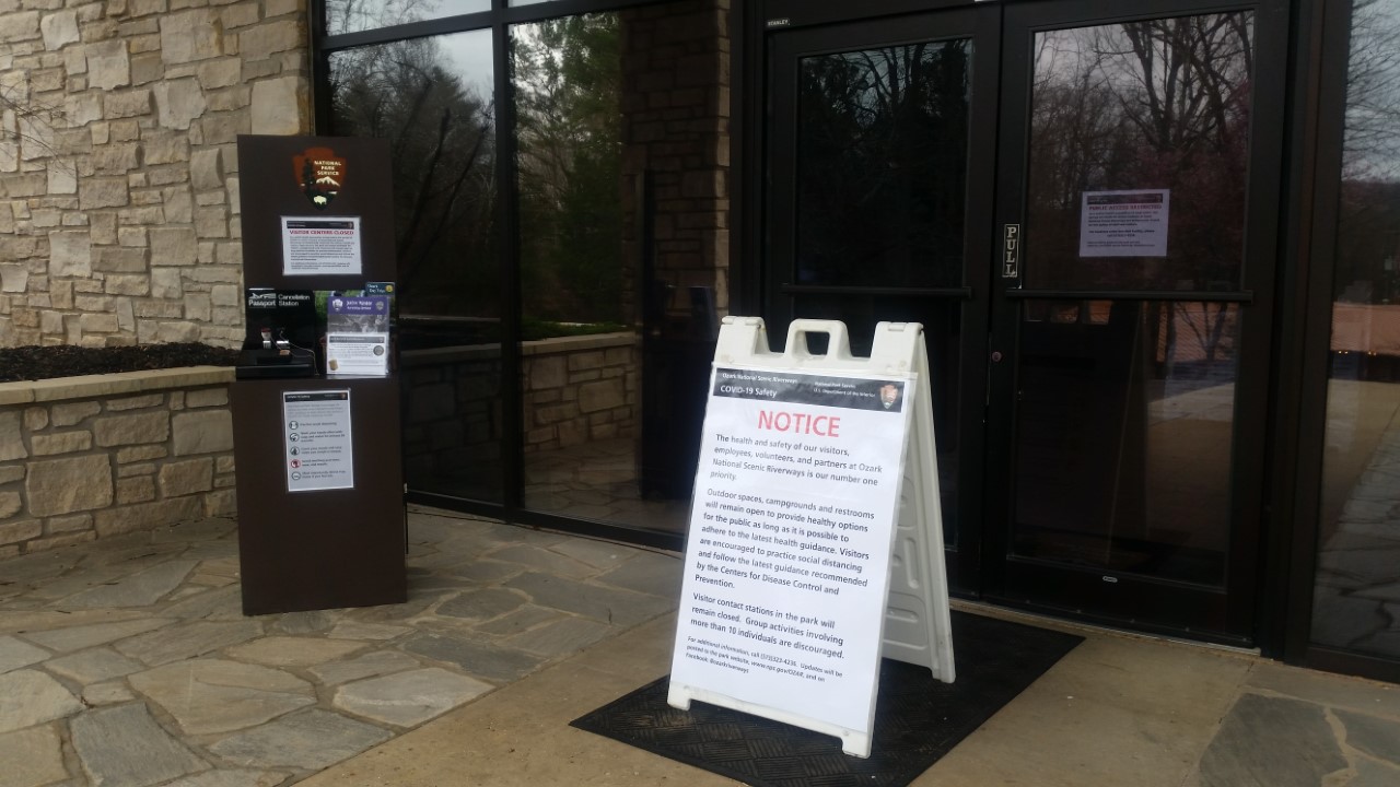 a frame sign that says attention in front of a visitor center