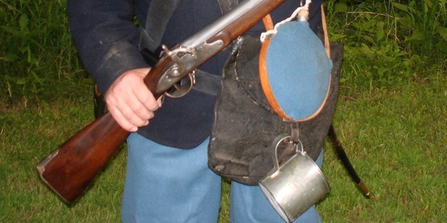 A Civil War reenactor holds his rifle