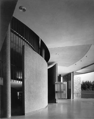 The "play of the curved and contrasting planes behind the rostrum" with a view of the landscape through the open doors