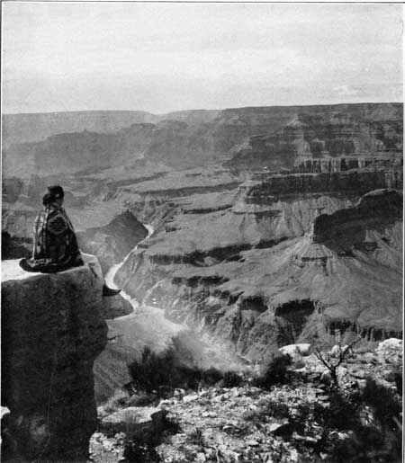 Native American sitting on mesa top