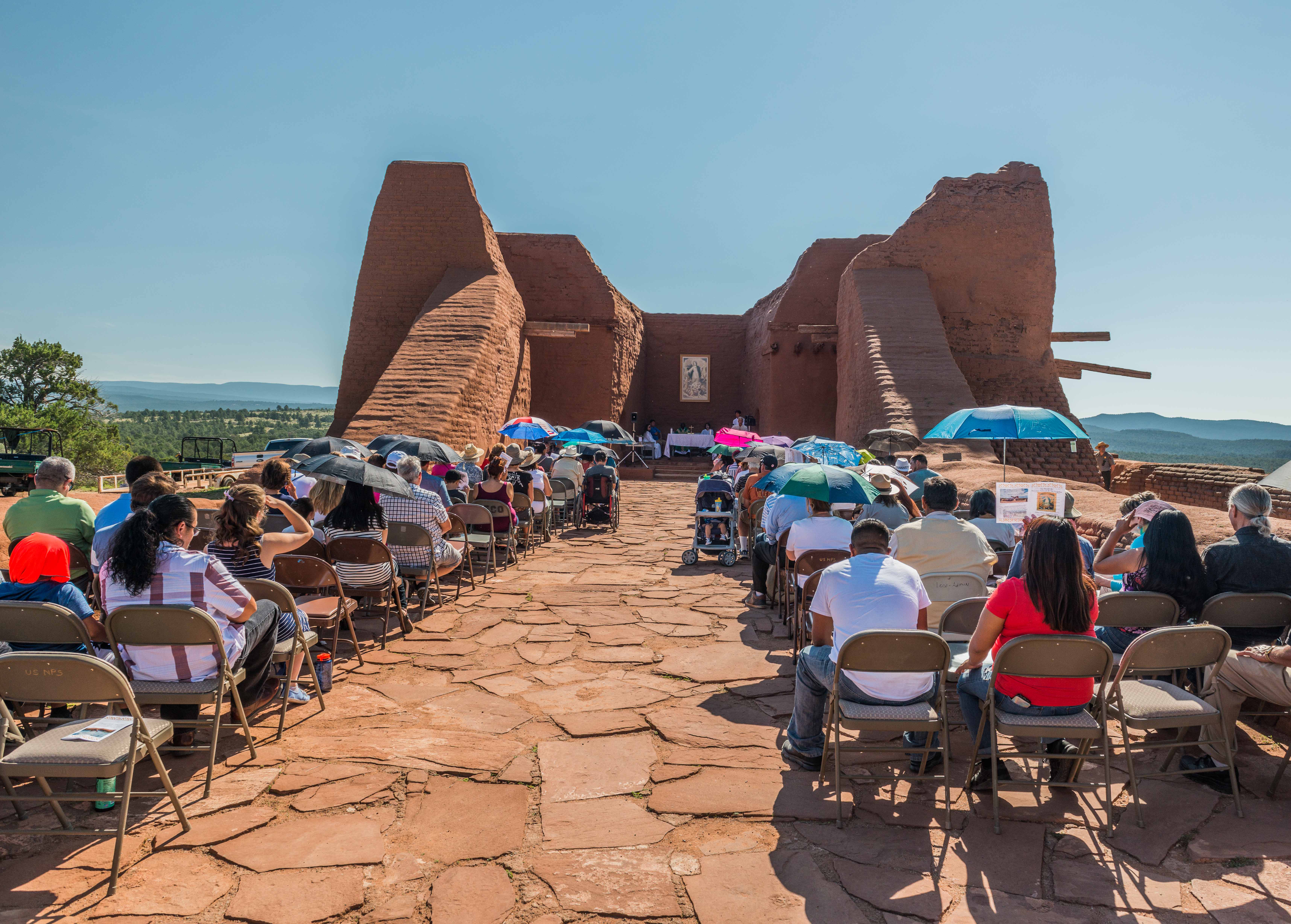 Feast Day Mass 2018 People sitting in rows in an ancient building.