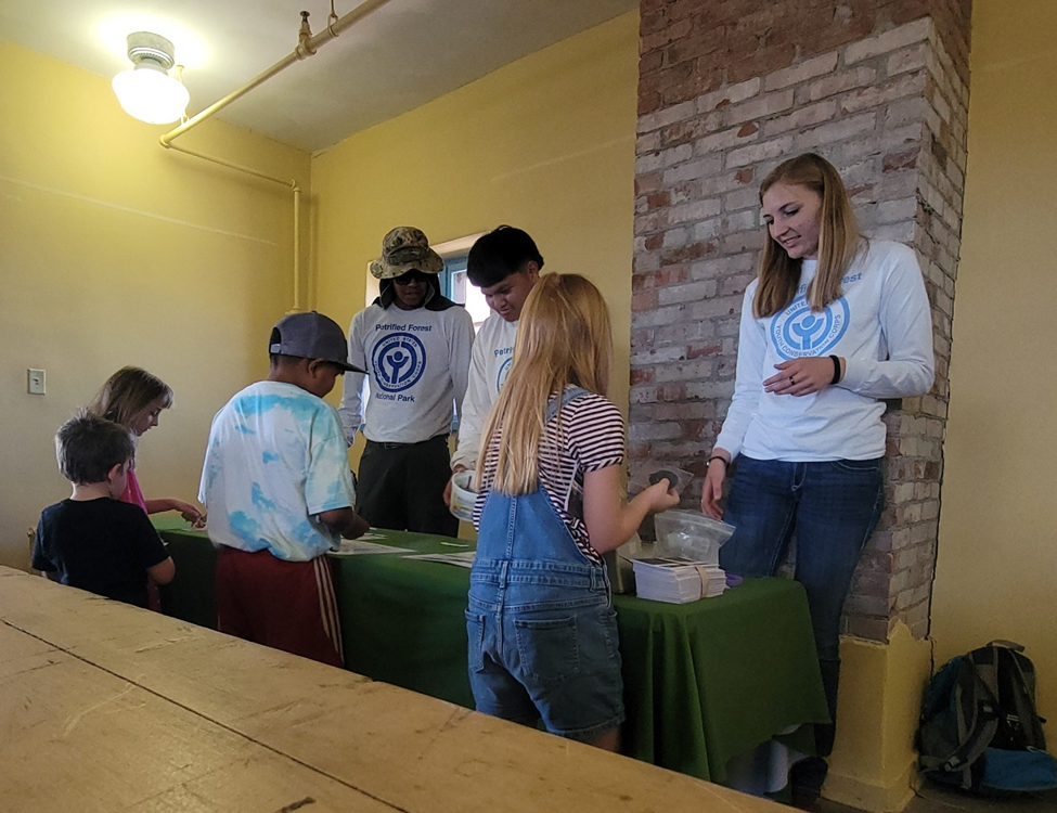 YCC crew members Skyler Joe, Kardell Morris, and Elenor Hansen give a presentation about fossils.