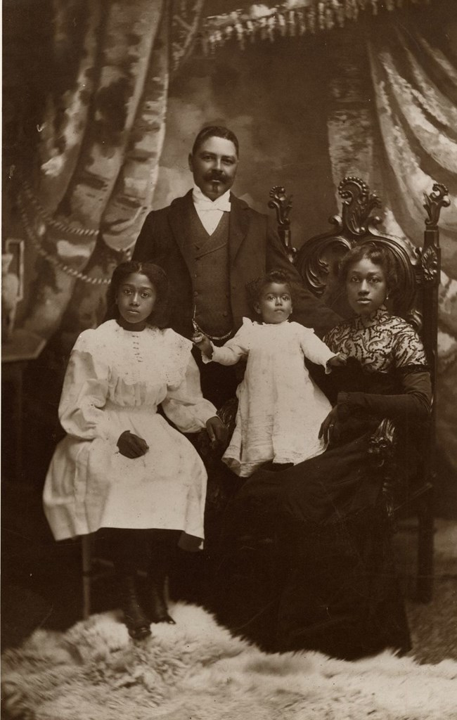 An old photo of Julia Ann Shelton Shorey sitting down with her husband Captain William T. Shorey, and her daughters, Zenobia Pearl and Victoria.