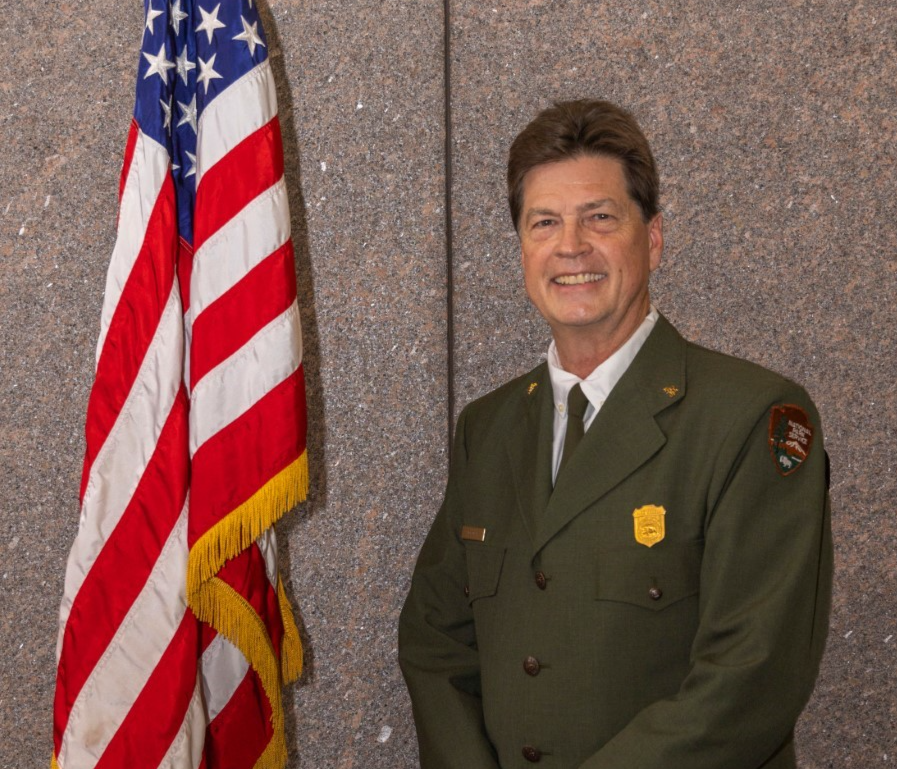 Person in green uniform with American flag