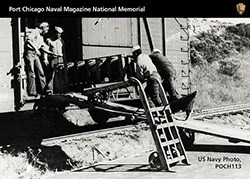 Trading Card showing African American male loading ammunition onto a train car.