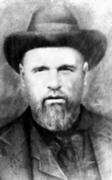 Black and white photo of a man, Elijah Nicholas "Uncle Nick" Wilson. He has beard and is wearing a hat.