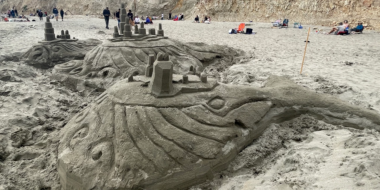 2024 Sand Sculpture Contest: People's Choice Award Winner: Adult Entry #2: Whale Village, by NorCal Sandcastles. September 7, 2024. A large sand sculpture of three whales on which small towers and terraces have been constructed.