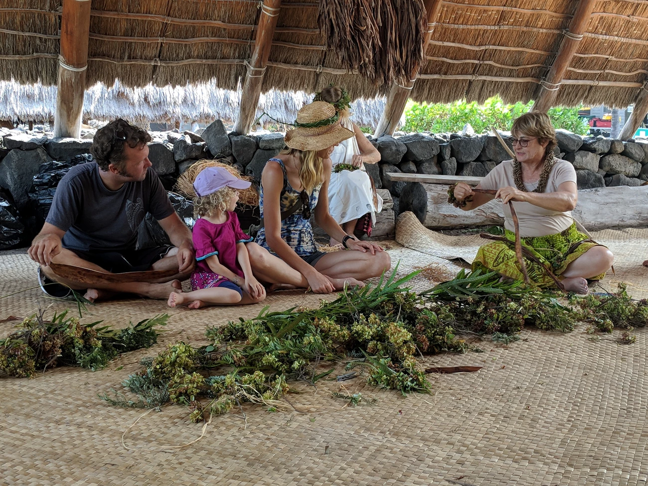 Family learning at Cultural Festival A family of four learns how to make a lei from a cultural demonstrator.