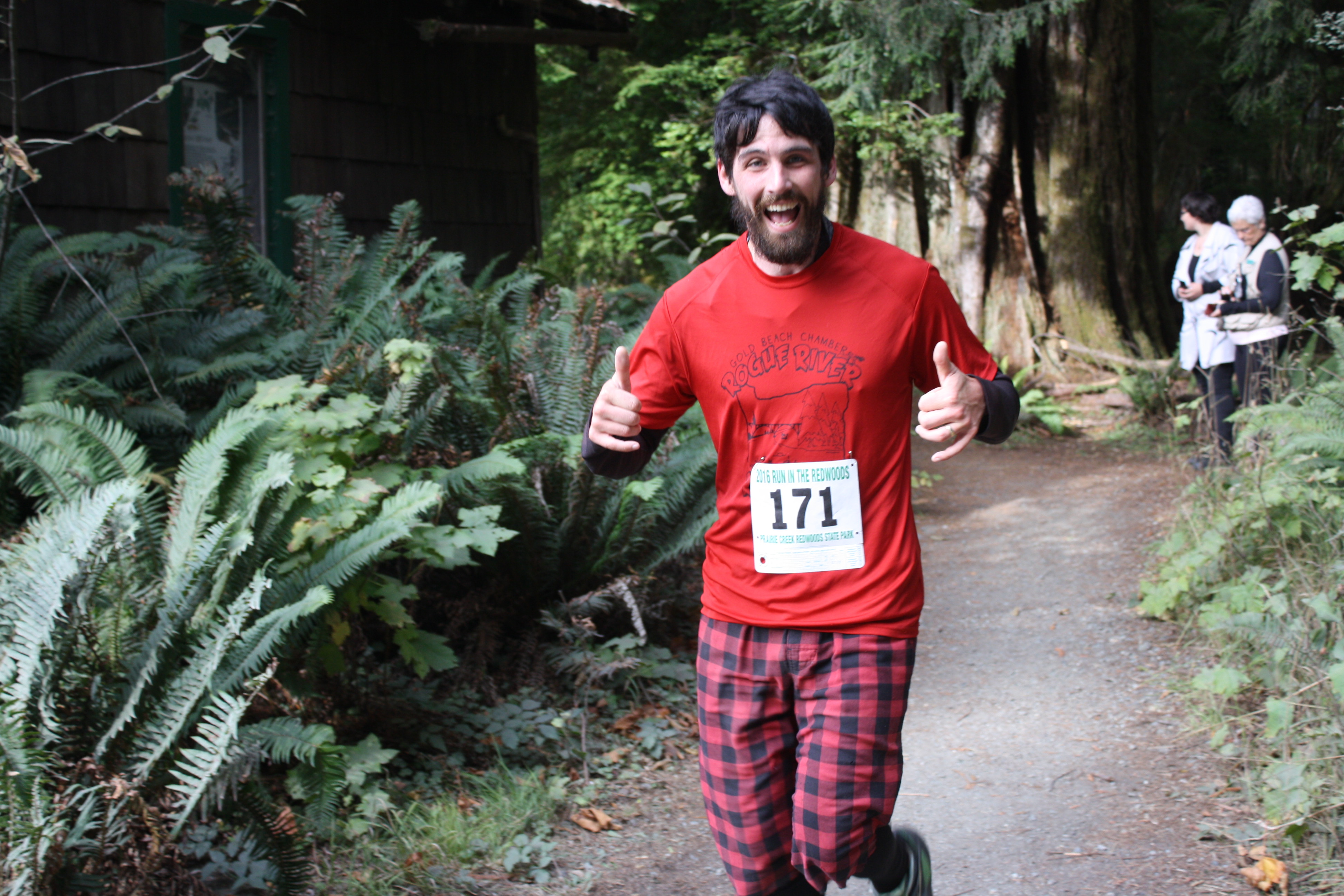 A runner smiles as he finishes the 5k fun-run