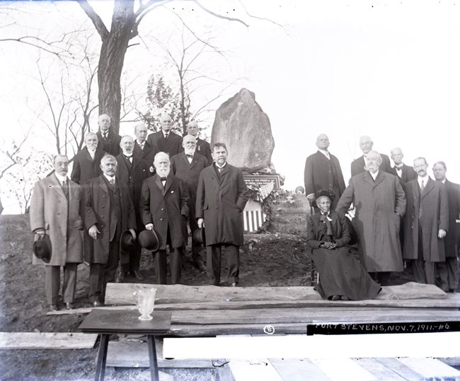 Elizabeth Proctor Thomas (seated) at Fort Stevens, poses for an image with Union and Confederate veterans at the dedication of the boulder marking the spot where President Abraham Lincoln was under fire at the Battle of Fort Stevens during the Civil War.