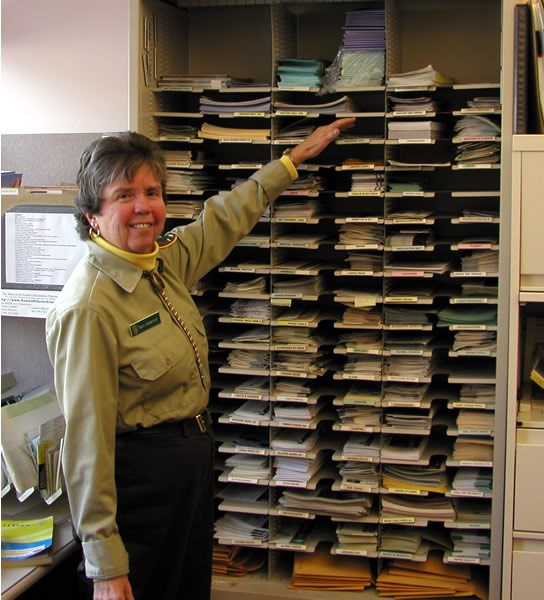 a photo of an Information Office volunteer locating publications