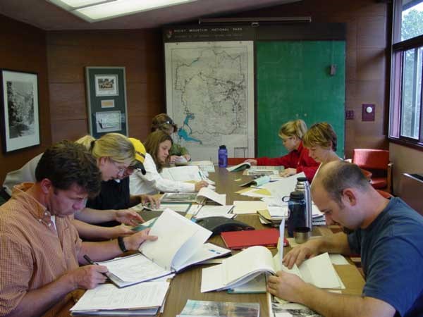 a photo of researchers checking archives