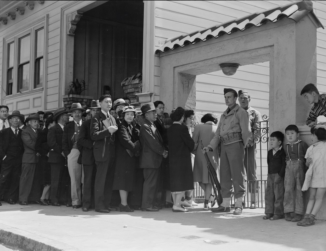 A crowd of Japanese American citizens reporting for relocation.