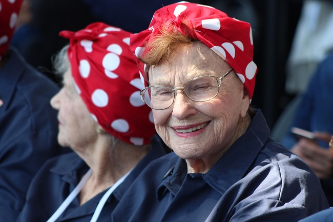 Senior caucasian female with glasses smiles for the camera.