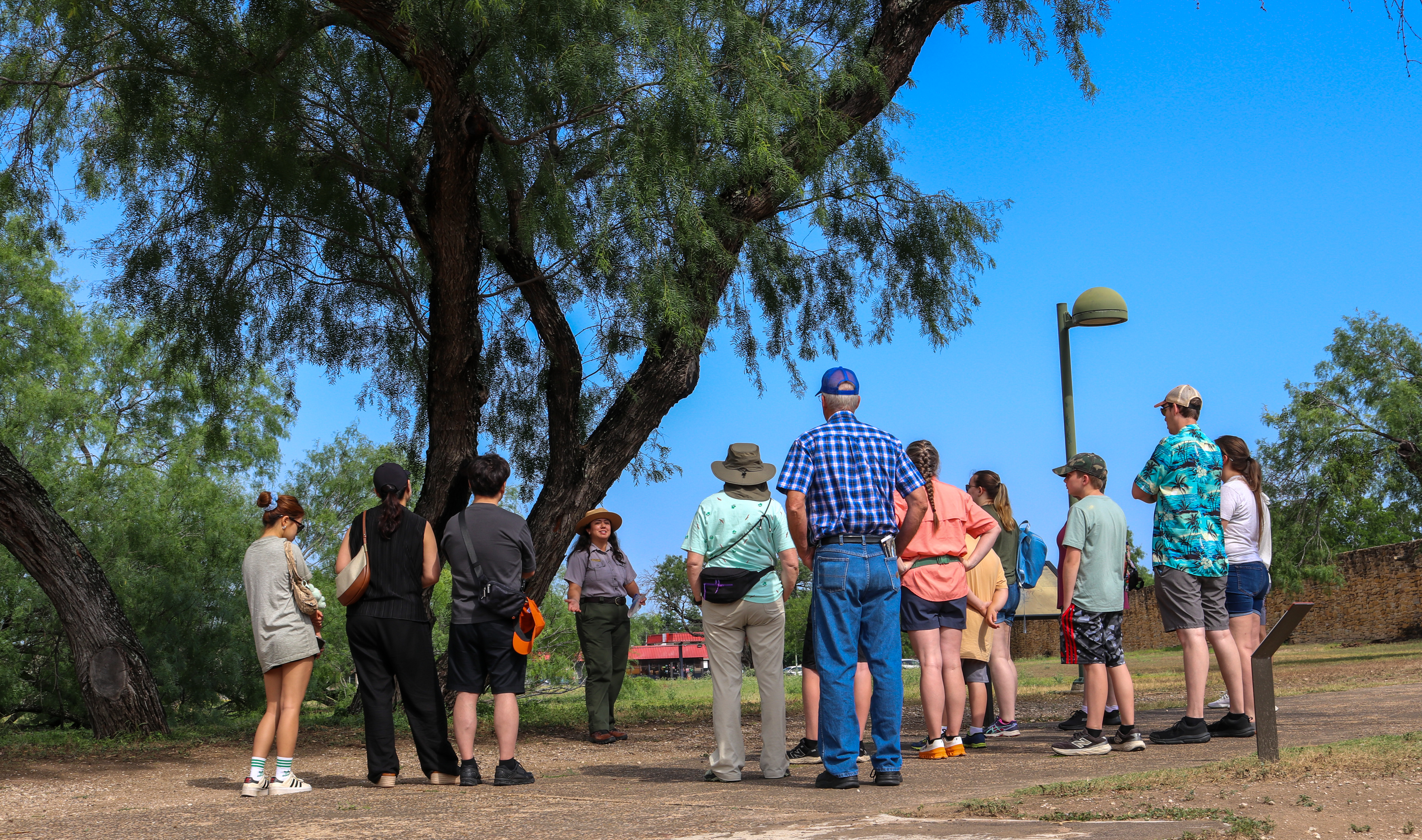 Female park ranger smiles while leading a tour