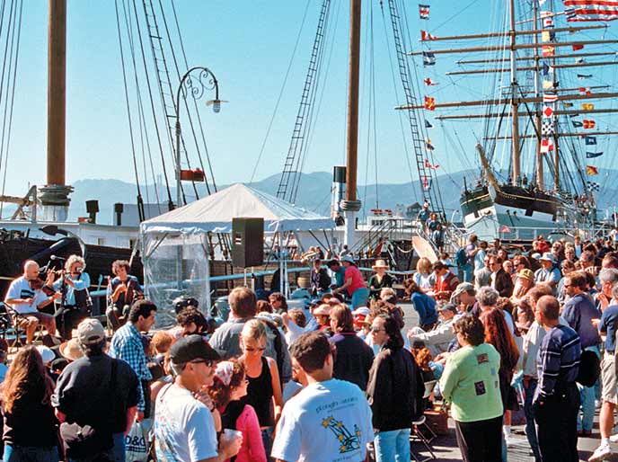 A large group of people on an outside pier.