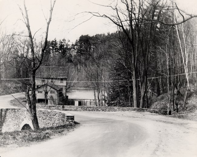 stone bridge with mill in distance