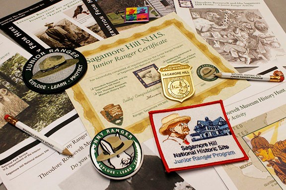 A variety of Junior Ranger booklets, badges, and patches from Sagamore Hill.