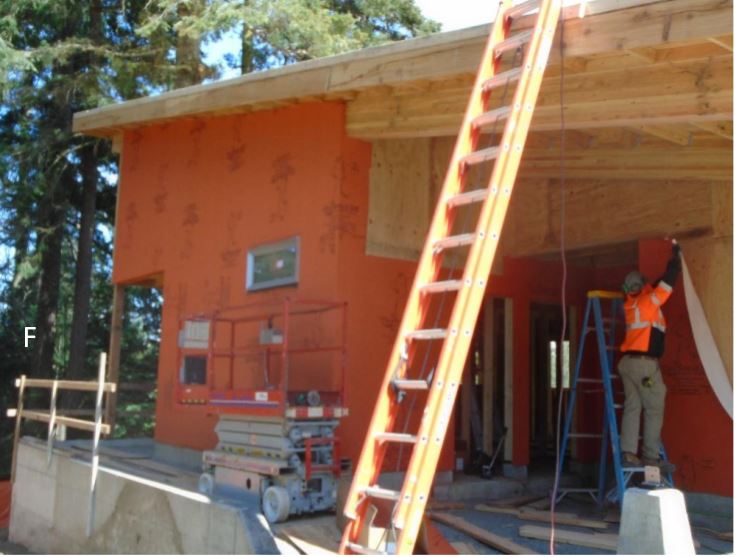 Orange WRB building wrap being installed