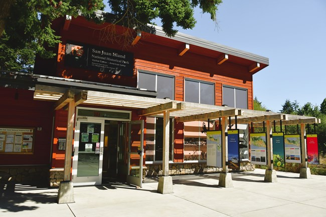 A building with a sign that reads "American Camp Visitor Center"