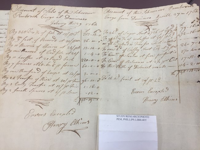 An shipping document with a list of items and columns of numbers written by hand in cursive with ink.