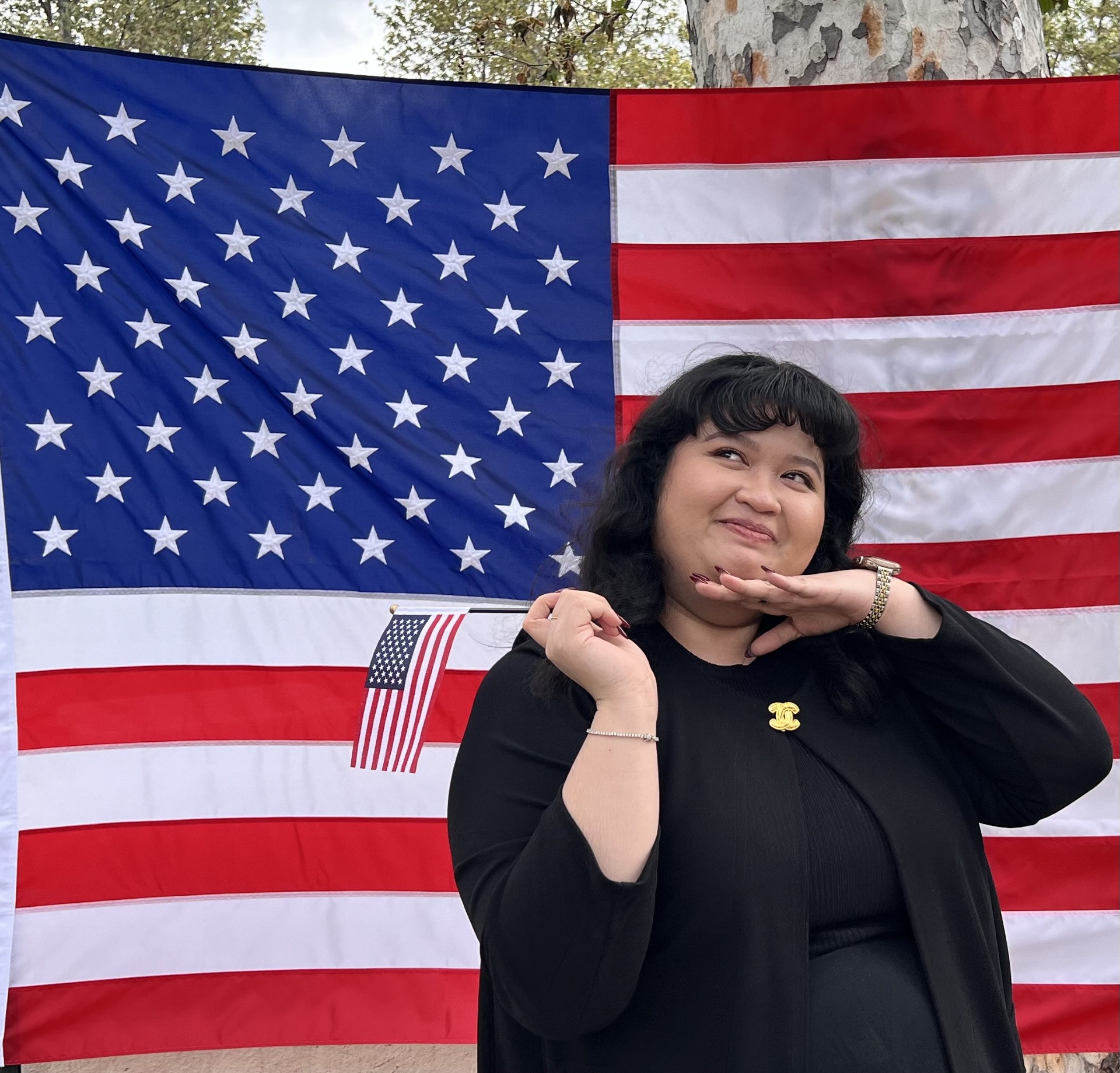 Woman posing in front of flag