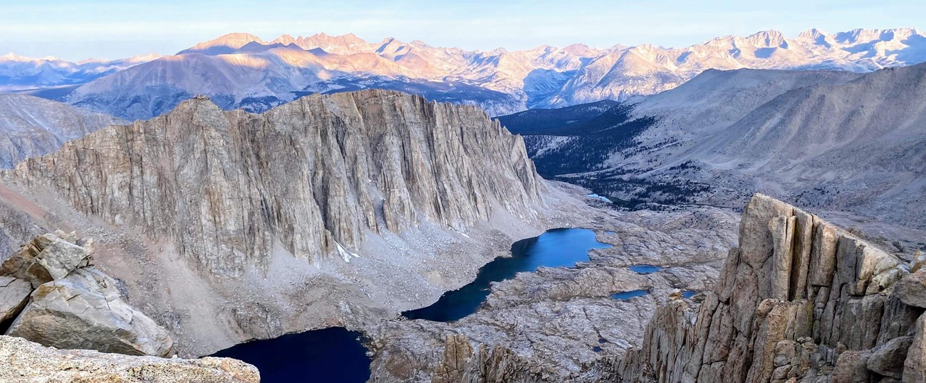 A series of lakes nestled in between mountain formations.