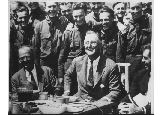 FDR Black and white image of FDR surrounded by men.