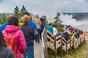 A long line of people on a boardwalk