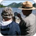 lt= Ranger and visitor talking near lake