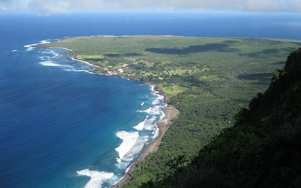 View to Kalaupapa Settlement View from the Pali Trail to Kalaupapa Peninsula, level and green surrounded by bright water.