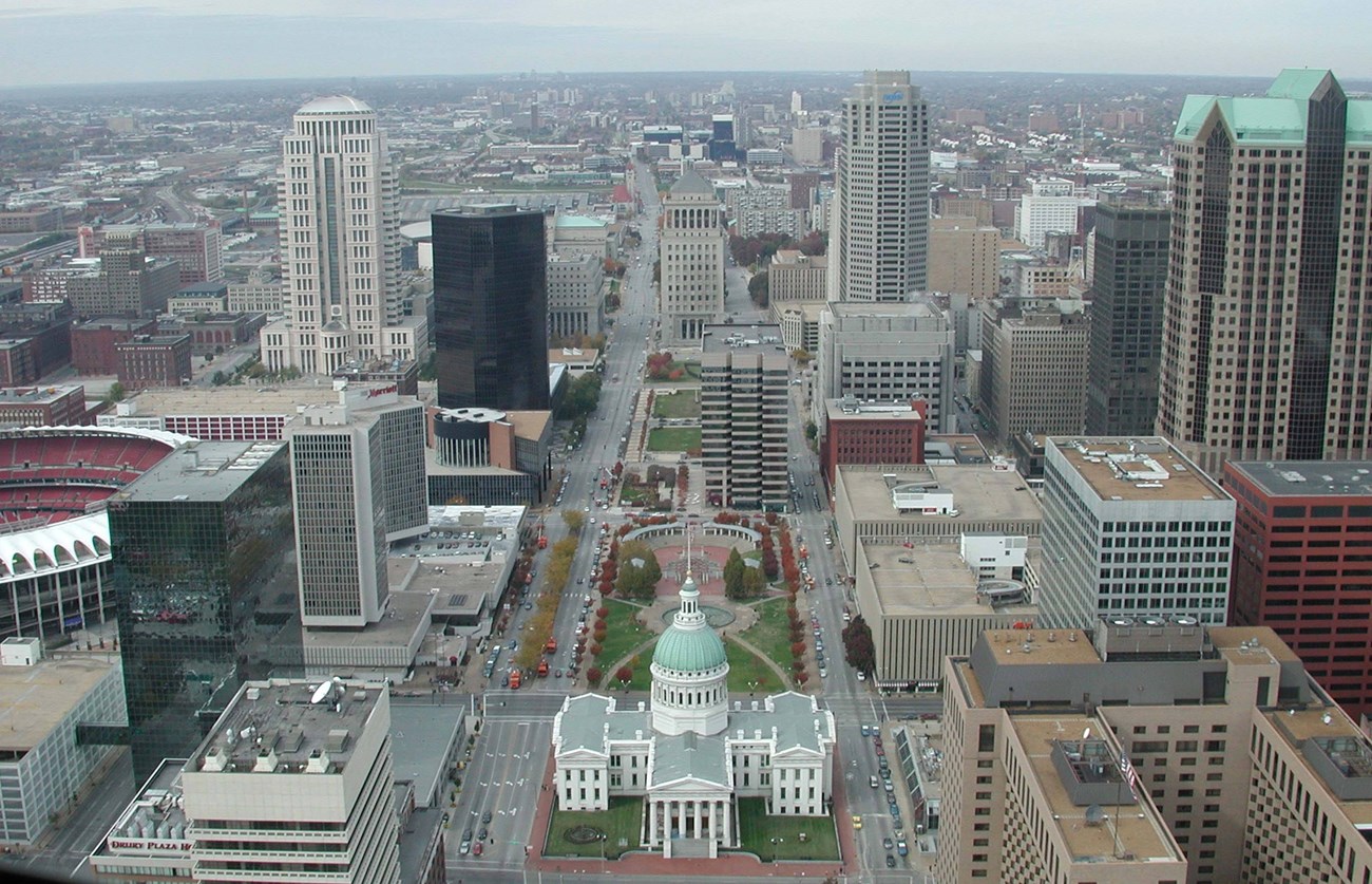 View of the Old Courthouse and surrounding landscape from Gateway Arch, framed by city streets and buildings of St. Louis