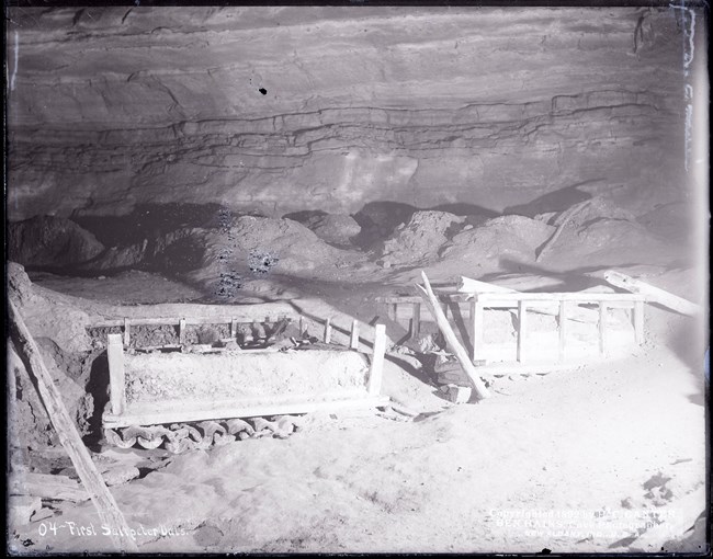 Saltpeter vats Two square vats formed by broken wooden frames in the interior floor of a cave