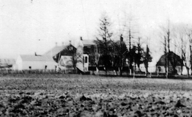 Main Worthington House at center surrounded by barns, outbuildings, fencing, and fields in the 1900s