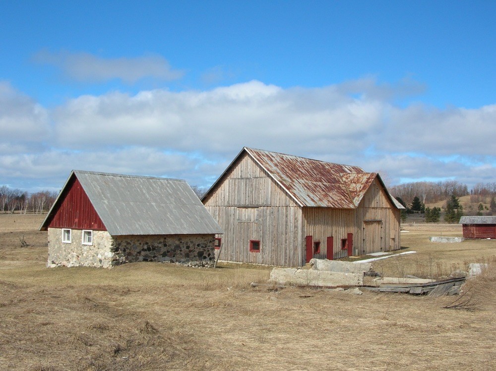 Farm buildings surrounded by open fields