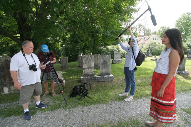 Video crew recording Bonney Hartley at Stockbridge Town Cemetery