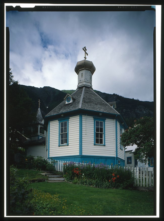 Small blue and white wooden church with dome