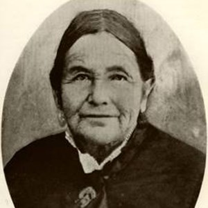 lt= Historic photo of elderly woman in black dress.